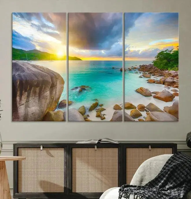 A triptych canvas of the Praslin Island Seychelles hangs on the wall. This vibrant beach sunset artwork features a UV-protective coating for lasting colors and comes with free shipping.