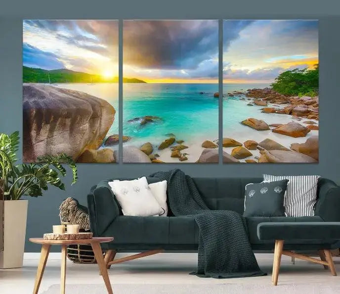 A triptych canvas of the Praslin Island Seychelles hangs on the wall. This vibrant beach sunset artwork features a UV-protective coating for lasting colors and comes with free shipping.