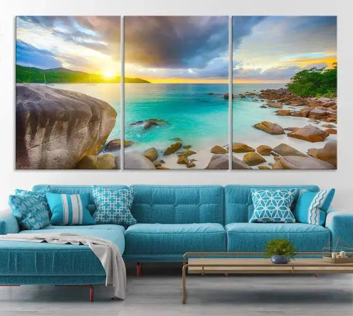 A triptych canvas of the Praslin Island Seychelles hangs on the wall. This vibrant beach sunset artwork features a UV-protective coating for lasting colors and comes with free shipping.