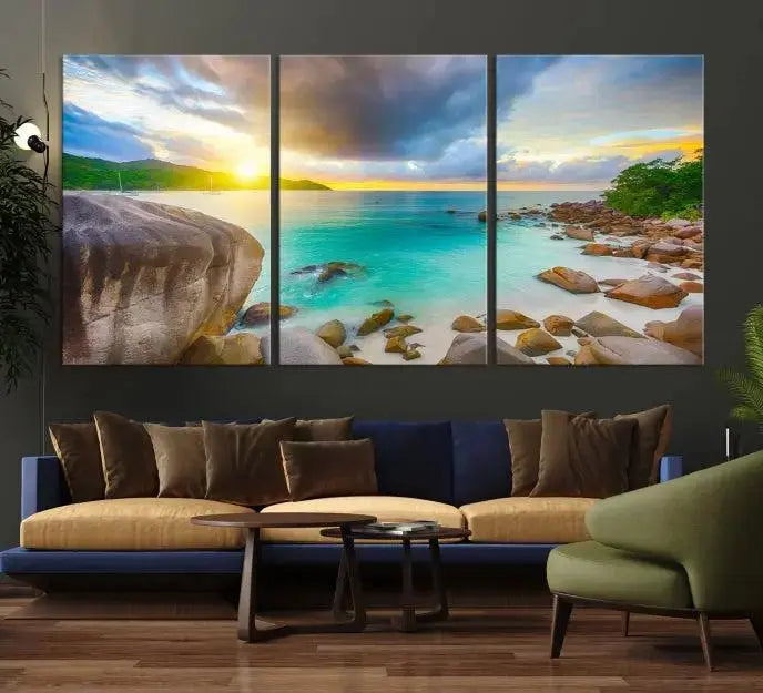 A triptych canvas of the Praslin Island Seychelles hangs on the wall. This vibrant beach sunset artwork features a UV-protective coating for lasting colors and comes with free shipping.