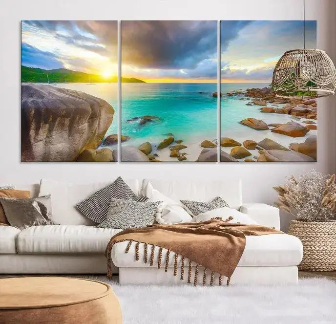 A triptych canvas of the Praslin Island Seychelles hangs on the wall. This vibrant beach sunset artwork features a UV-protective coating for lasting colors and comes with free shipping.