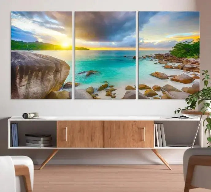 A triptych canvas of the Praslin Island Seychelles hangs on the wall. This vibrant beach sunset artwork features a UV-protective coating for lasting colors and comes with free shipping.