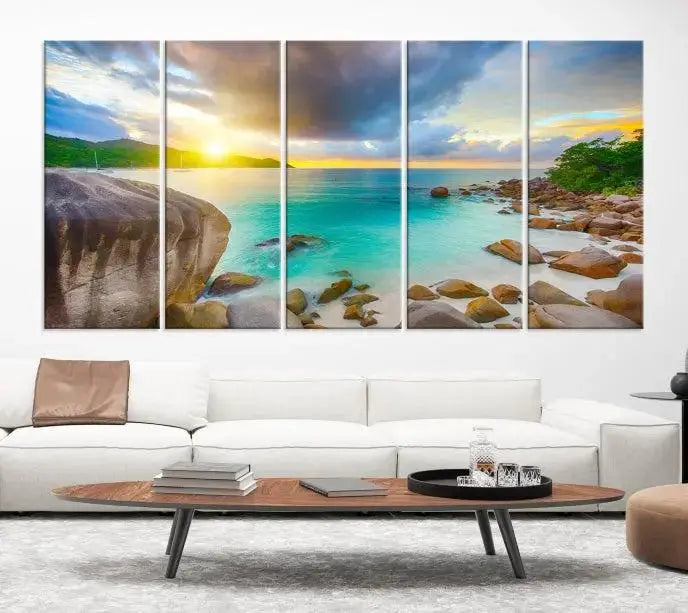 A triptych canvas of the Praslin Island Seychelles hangs on the wall. This vibrant beach sunset artwork features a UV-protective coating for lasting colors and comes with free shipping.