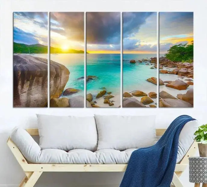 A triptych canvas of the Praslin Island Seychelles hangs on the wall. This vibrant beach sunset artwork features a UV-protective coating for lasting colors and comes with free shipping.