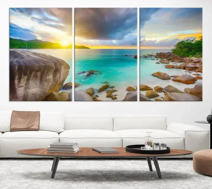 A triptych canvas of the Praslin Island Seychelles hangs on the wall. This vibrant beach sunset artwork features a UV-protective coating for lasting colors and comes with free shipping.