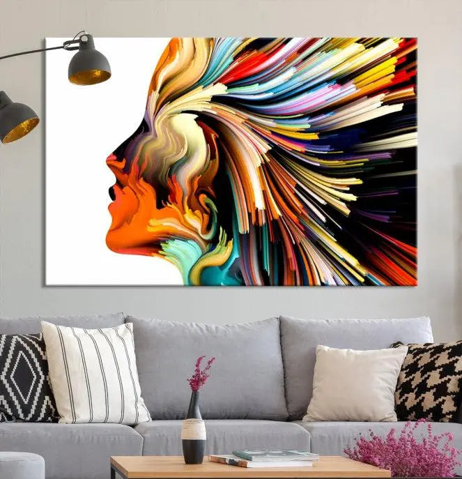 The "Profile Colors Canvas Print," featuring a colorful abstract face on museum-quality canvas, graces the wall.