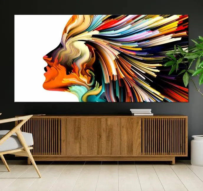 The "Profile Colors Canvas Print," featuring a colorful abstract face on museum-quality canvas, graces the wall.