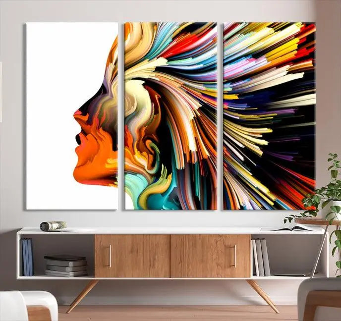 The "Profile Colors Canvas Print," featuring a colorful abstract face on museum-quality canvas, graces the wall.