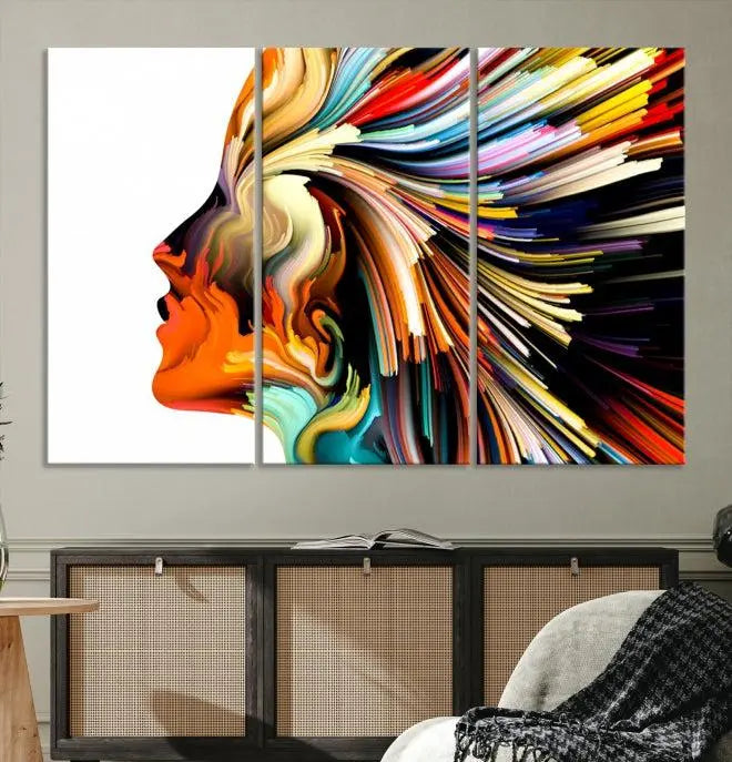 The "Profile Colors Canvas Print," featuring a colorful abstract face on museum-quality canvas, graces the wall.