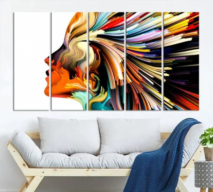 The "Profile Colors Canvas Print," featuring a colorful abstract face on museum-quality canvas, graces the wall.