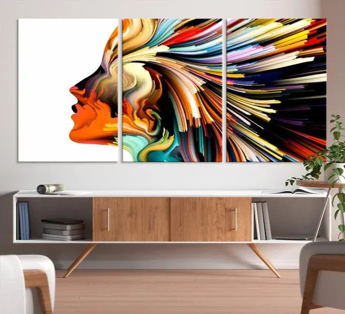 The "Profile Colors Canvas Print," featuring a colorful abstract face on museum-quality canvas, graces the wall.