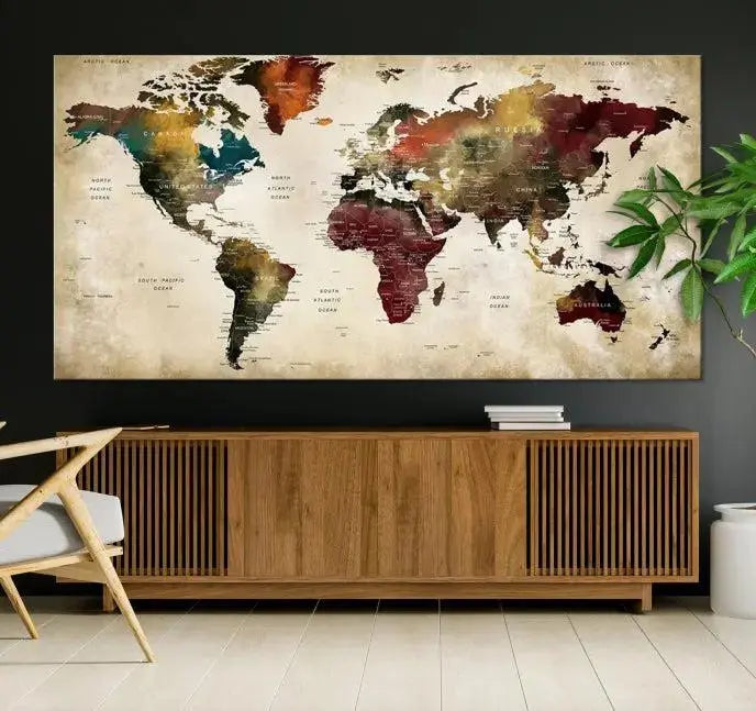 A Push Pin Watercolor World Map on a grunge background, printed on museum-quality canvases and gallery wrapped for a polished finish, hangs prominently on the wall.