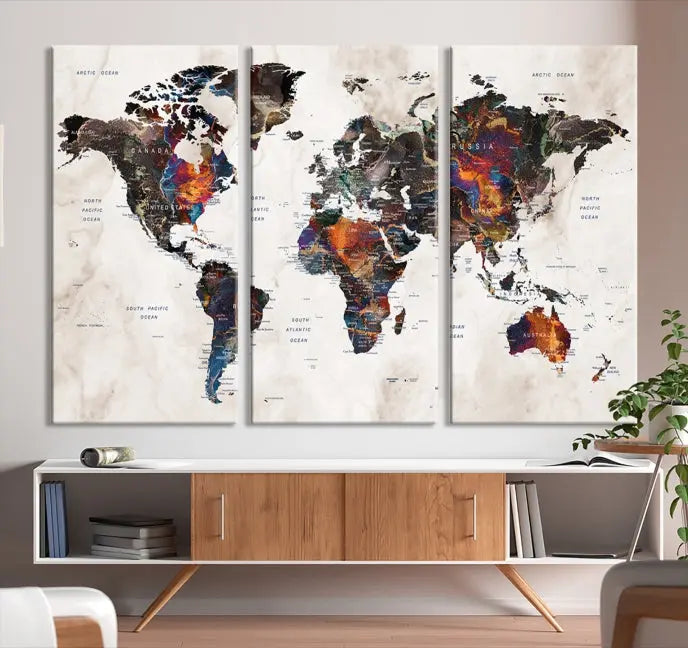 The "Push Pin World Map Painting Canvas Wall Art Print," a vibrant five-panel artwork with a gallery wrap and UV-protective coating, is displayed against a dark wall.