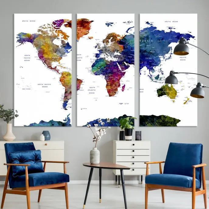 A modern living room is beautifully adorned with the Push Pin World Map Wall Art Canvas Print, a vibrant triptych of colorful world maps crafted on museum-quality canvas and perfectly gallery wrapped. This striking artwork stands out on its own, enhancing the room's overall aesthetics.