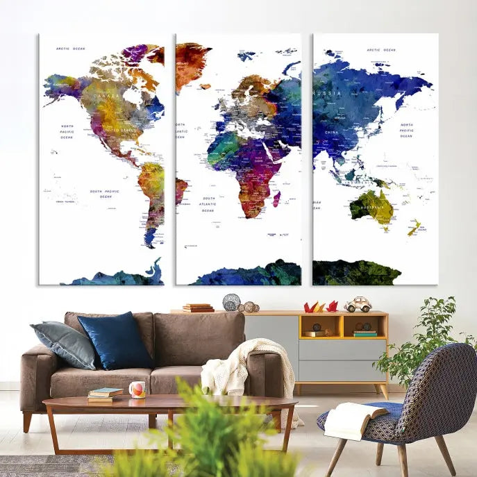 A modern living room is beautifully adorned with the Push Pin World Map Wall Art Canvas Print, a vibrant triptych of colorful world maps crafted on museum-quality canvas and perfectly gallery wrapped. This striking artwork stands out on its own, enhancing the room's overall aesthetics.