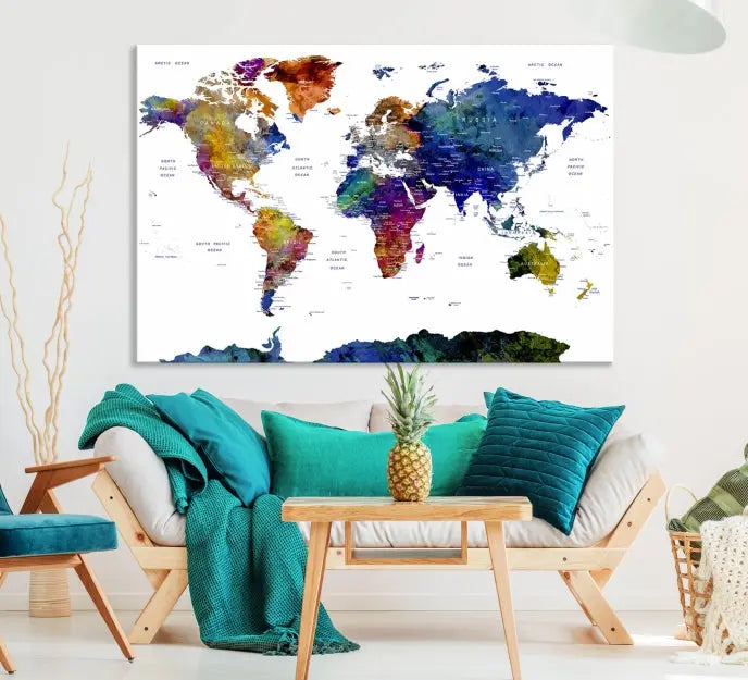 A modern living room is beautifully adorned with the Push Pin World Map Wall Art Canvas Print, a vibrant triptych of colorful world maps crafted on museum-quality canvas and perfectly gallery wrapped. This striking artwork stands out on its own, enhancing the room's overall aesthetics.