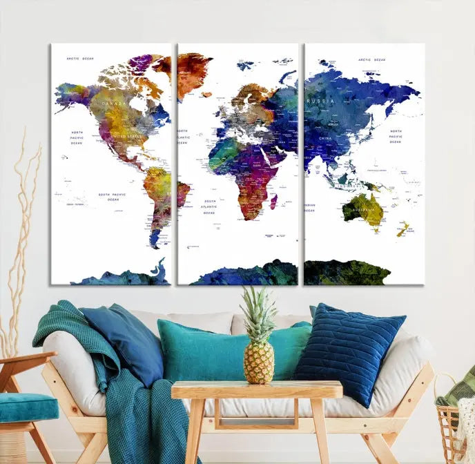 A modern living room is beautifully adorned with the Push Pin World Map Wall Art Canvas Print, a vibrant triptych of colorful world maps crafted on museum-quality canvas and perfectly gallery wrapped. This striking artwork stands out on its own, enhancing the room's overall aesthetics.