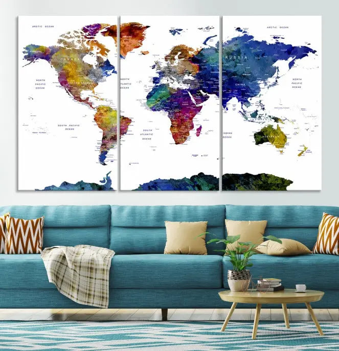 A modern living room is beautifully adorned with the Push Pin World Map Wall Art Canvas Print, a vibrant triptych of colorful world maps crafted on museum-quality canvas and perfectly gallery wrapped. This striking artwork stands out on its own, enhancing the room's overall aesthetics.