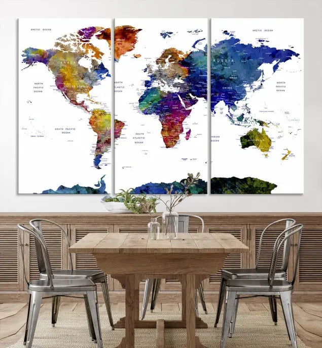 A modern living room is beautifully adorned with the Push Pin World Map Wall Art Canvas Print, a vibrant triptych of colorful world maps crafted on museum-quality canvas and perfectly gallery wrapped. This striking artwork stands out on its own, enhancing the room's overall aesthetics.