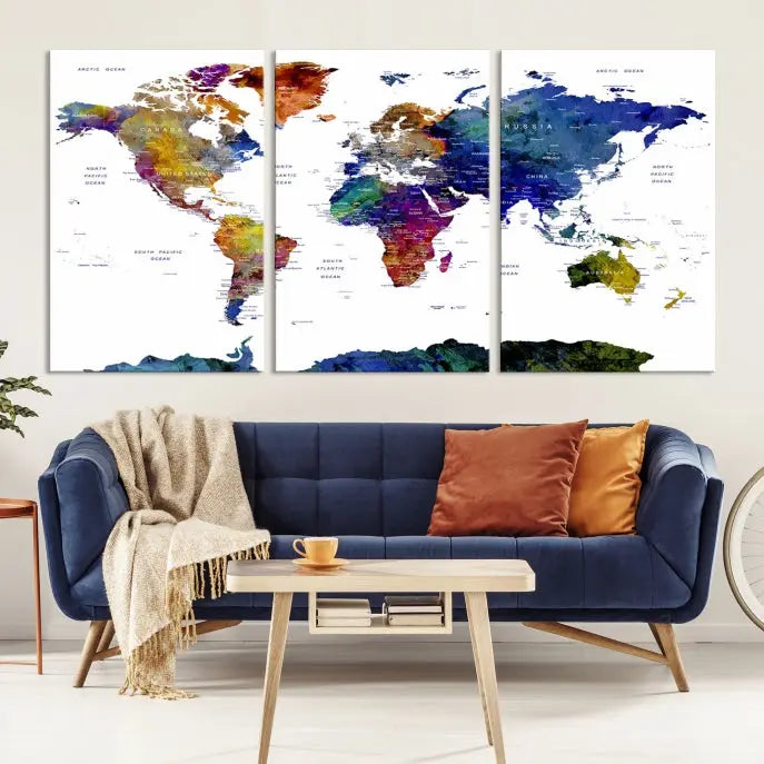 A modern living room is beautifully adorned with the Push Pin World Map Wall Art Canvas Print, a vibrant triptych of colorful world maps crafted on museum-quality canvas and perfectly gallery wrapped. This striking artwork stands out on its own, enhancing the room's overall aesthetics.