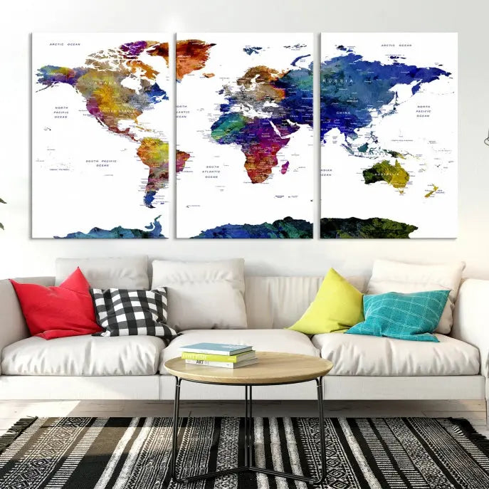 A modern living room is beautifully adorned with the Push Pin World Map Wall Art Canvas Print, a vibrant triptych of colorful world maps crafted on museum-quality canvas and perfectly gallery wrapped. This striking artwork stands out on its own, enhancing the room's overall aesthetics.