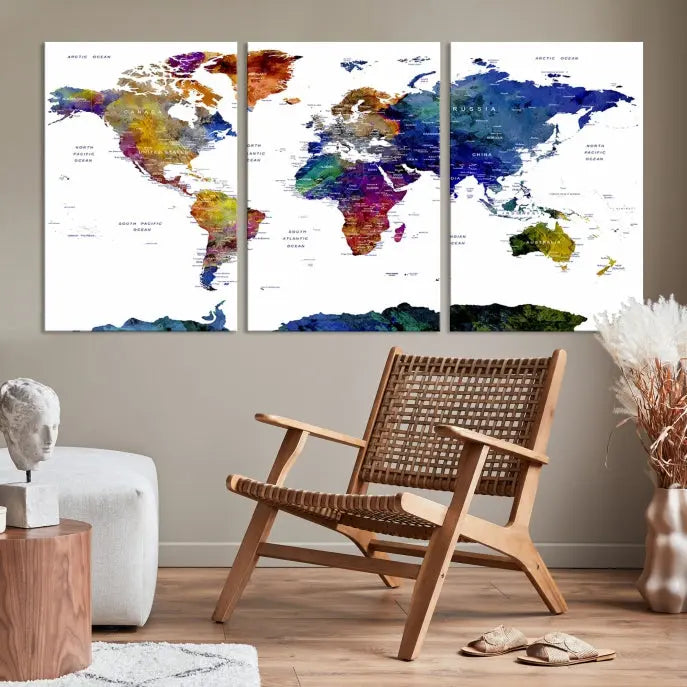 A modern living room is beautifully adorned with the Push Pin World Map Wall Art Canvas Print, a vibrant triptych of colorful world maps crafted on museum-quality canvas and perfectly gallery wrapped. This striking artwork stands out on its own, enhancing the room's overall aesthetics.