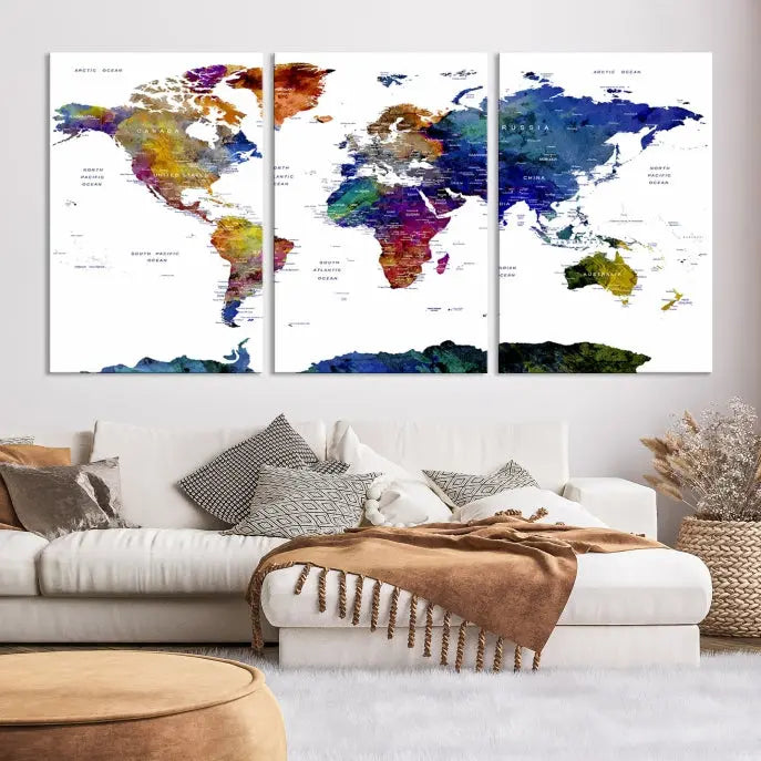 A modern living room is beautifully adorned with the Push Pin World Map Wall Art Canvas Print, a vibrant triptych of colorful world maps crafted on museum-quality canvas and perfectly gallery wrapped. This striking artwork stands out on its own, enhancing the room's overall aesthetics.