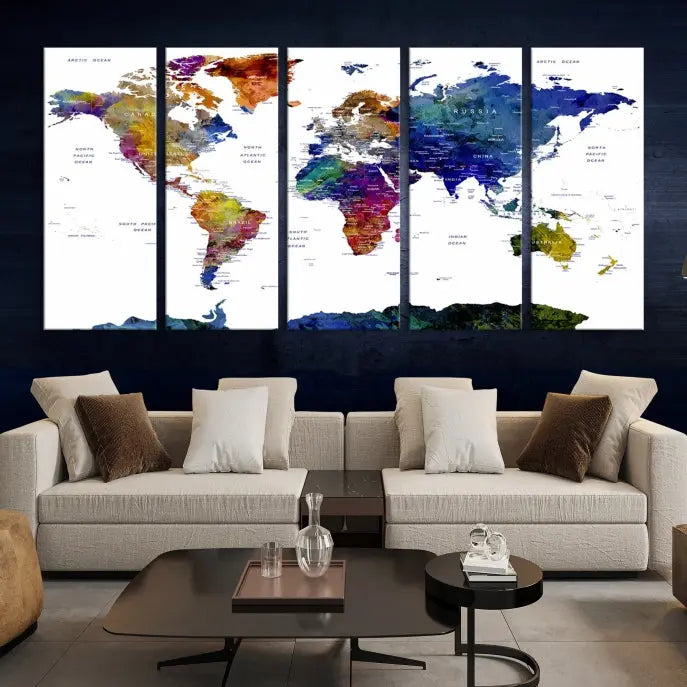 A modern living room is beautifully adorned with the Push Pin World Map Wall Art Canvas Print, a vibrant triptych of colorful world maps crafted on museum-quality canvas and perfectly gallery wrapped. This striking artwork stands out on its own, enhancing the room's overall aesthetics.