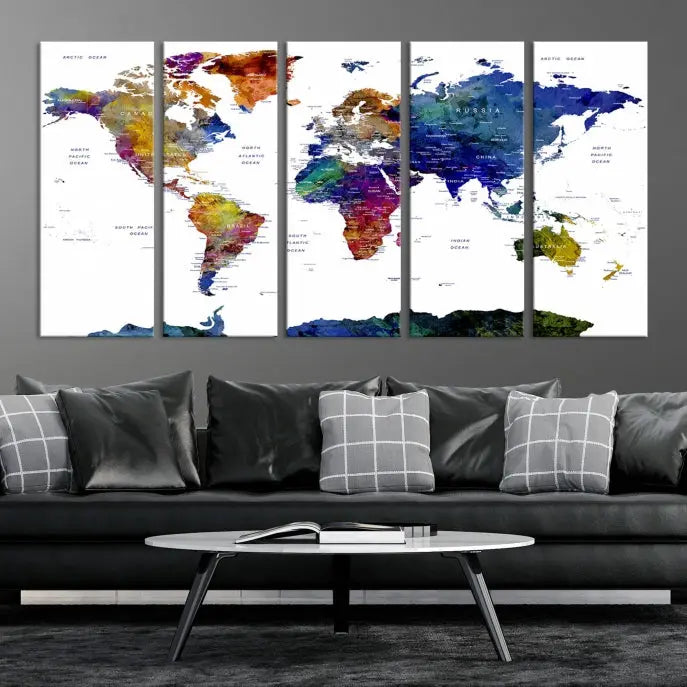 A modern living room is beautifully adorned with the Push Pin World Map Wall Art Canvas Print, a vibrant triptych of colorful world maps crafted on museum-quality canvas and perfectly gallery wrapped. This striking artwork stands out on its own, enhancing the room's overall aesthetics.