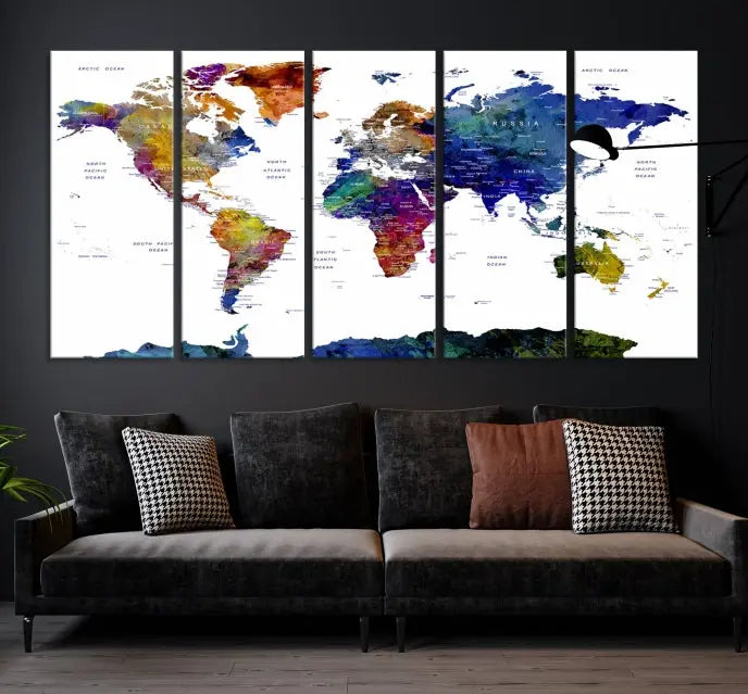 A modern living room is beautifully adorned with the Push Pin World Map Wall Art Canvas Print, a vibrant triptych of colorful world maps crafted on museum-quality canvas and perfectly gallery wrapped. This striking artwork stands out on its own, enhancing the room's overall aesthetics.