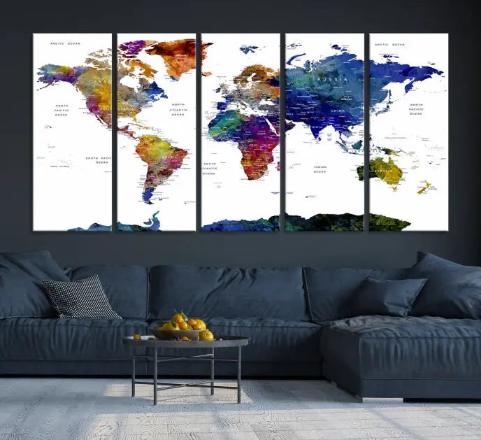 A modern living room is beautifully adorned with the Push Pin World Map Wall Art Canvas Print, a vibrant triptych of colorful world maps crafted on museum-quality canvas and perfectly gallery wrapped. This striking artwork stands out on its own, enhancing the room's overall aesthetics.