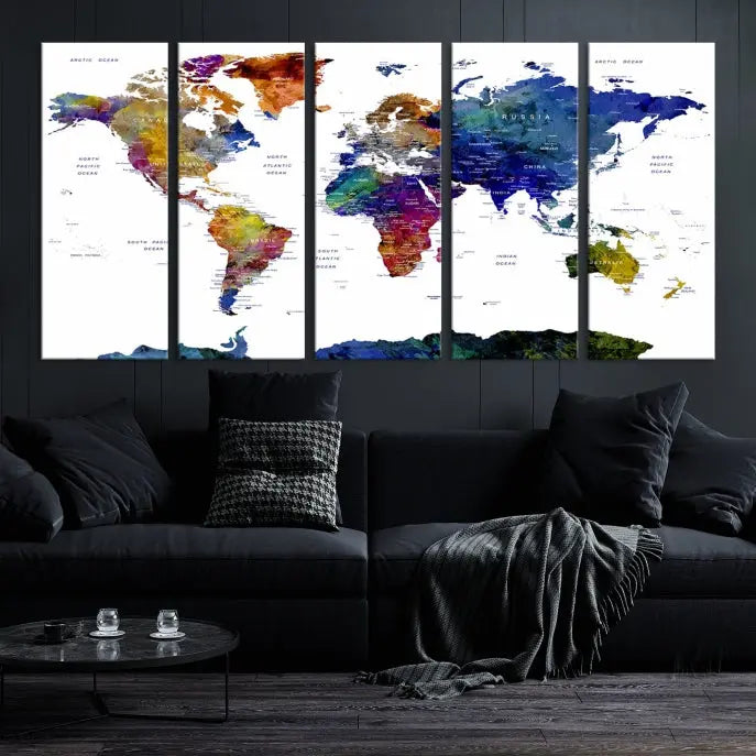 A modern living room is beautifully adorned with the Push Pin World Map Wall Art Canvas Print, a vibrant triptych of colorful world maps crafted on museum-quality canvas and perfectly gallery wrapped. This striking artwork stands out on its own, enhancing the room's overall aesthetics.