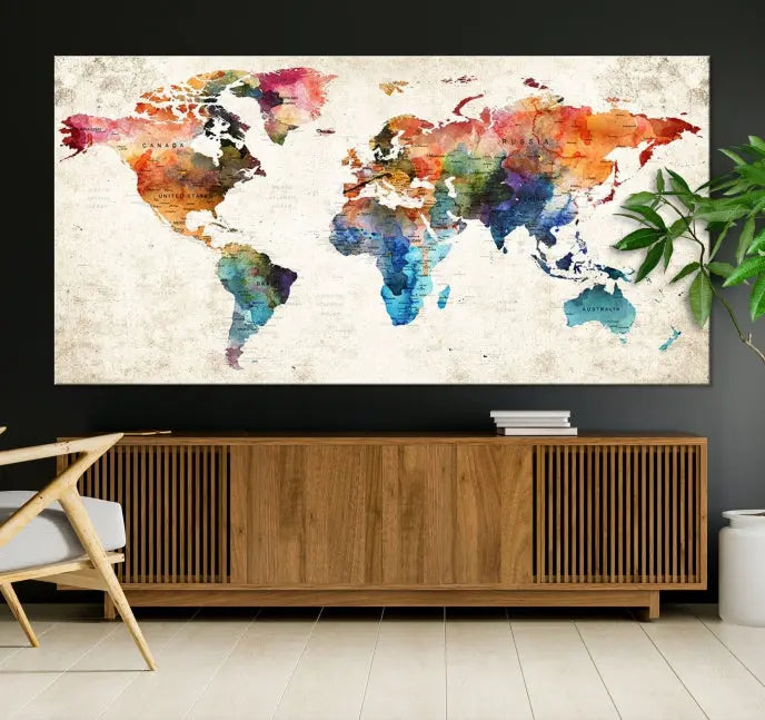 A Push Pin World Map Wall Art Canvas Print with a colorful abstract design and UV-protective coating is displayed on the wall.