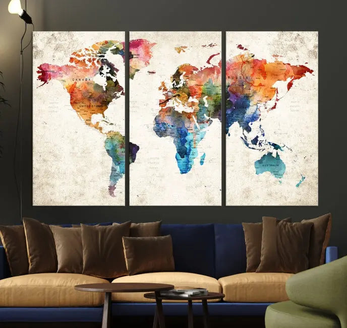 A Push Pin World Map Wall Art Canvas Print with a colorful abstract design and UV-protective coating is displayed on the wall.