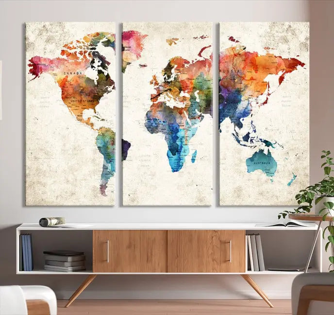 A Push Pin World Map Wall Art Canvas Print with a colorful abstract design and UV-protective coating is displayed on the wall.