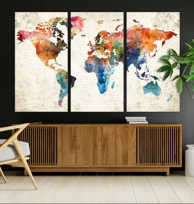 A Push Pin World Map Wall Art Canvas Print with a colorful abstract design and UV-protective coating is displayed on the wall.