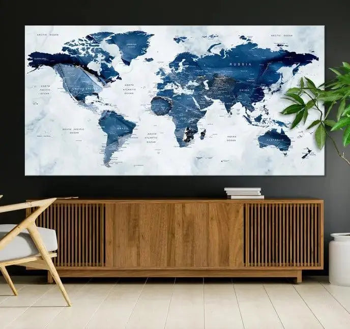 A Push Pin World Map Watercolor Wall Art Canvas Print in shades of blue and white is displayed.