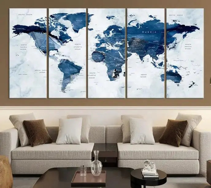 A Push Pin World Map Watercolor Wall Art Canvas Print in shades of blue and white is displayed.