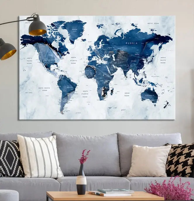 A Push Pin World Map Watercolor Wall Art Canvas Print in shades of blue and white is displayed.