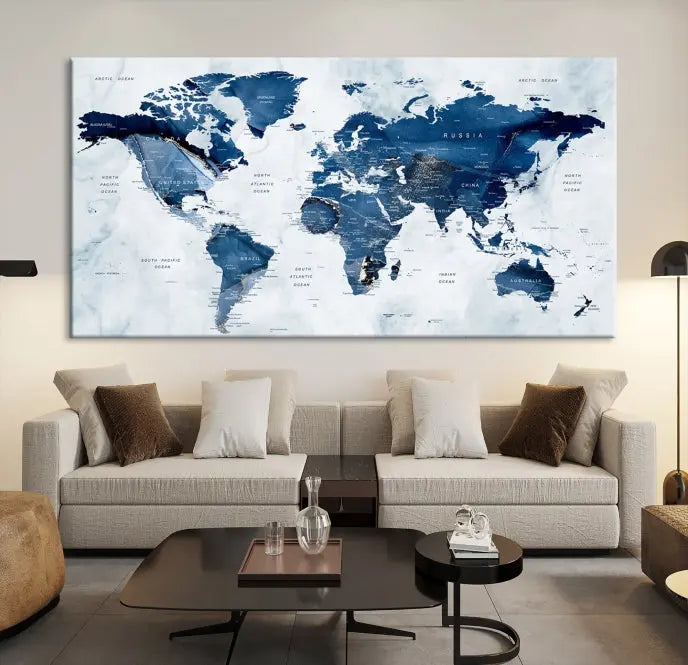 A Push Pin World Map Watercolor Wall Art Canvas Print in shades of blue and white is displayed.