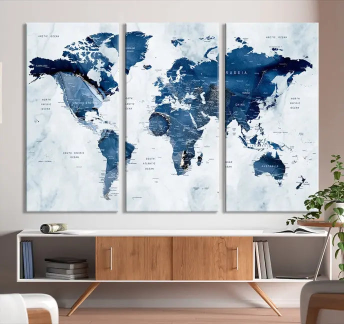 A Push Pin World Map Watercolor Wall Art Canvas Print in shades of blue and white is displayed.