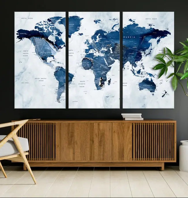 A Push Pin World Map Watercolor Wall Art Canvas Print in shades of blue and white is displayed.