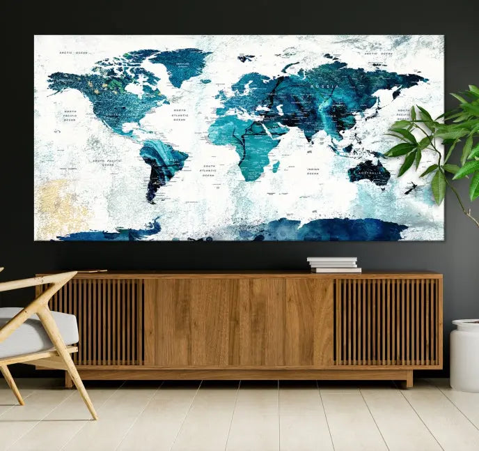 A modern living room showcases a Push Pin World Map with Antarctica, elegantly displayed on museum-quality canvas.