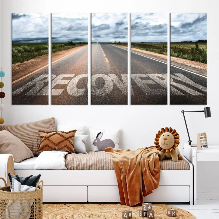 The Recovery Road Wall Art Canvas Print, a three-panel piece gallery wrapped on museum-quality canvas, displays an empty road with the word RECOVERY painted on it. This artwork is coated with UV-protection to maintain its vibrant colors over time.