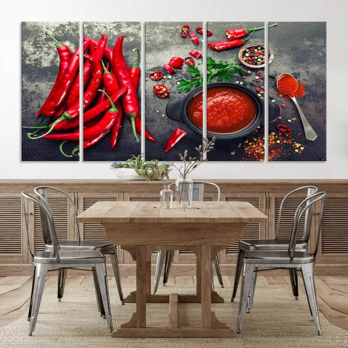 The Red Chili Peppers Wall Art Kitchen Artwork Canvas Print is a three-panel canvas showcasing red chili peppers, sliced chili, a pot of red sauce, and assorted spices on a dark background. It is of museum quality with a UV-protective coating to ensure its colors remain vibrant over time.