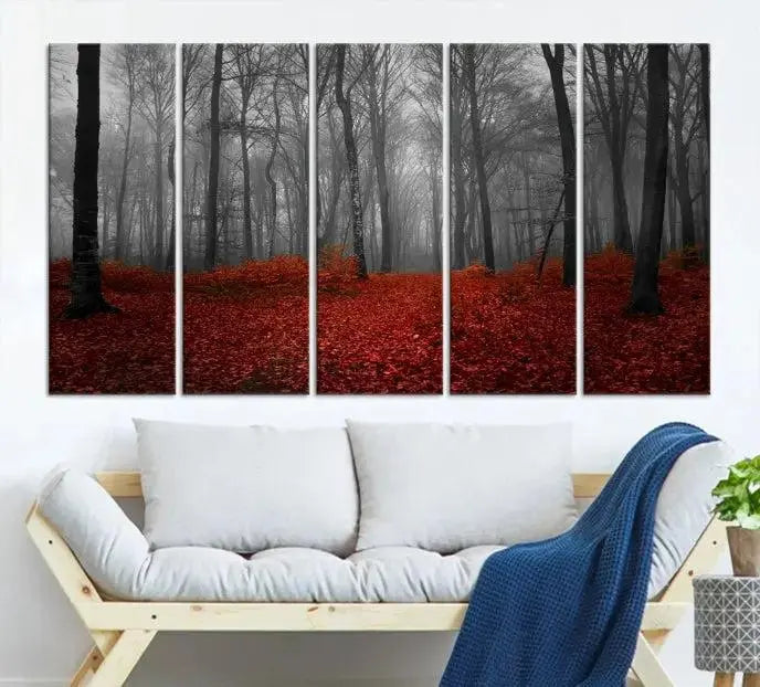 The Red Forest Floor Canvas Wall Art, a mystical foggy woodland triptych, is elegantly displayed on the wall. This nature-inspired decor transforms your space into an enchanting retreat.
