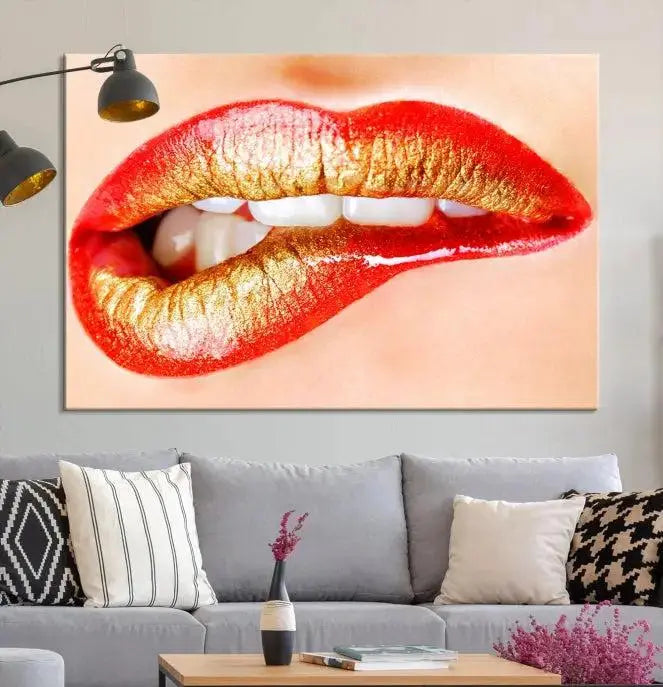 The Red Lip Bite Canvas Print, featuring a triptych of lips with red and gold lipstick, is elegantly displayed, enhancing the modern aesthetic of the minimalist room decor. This artwork is printed on high-quality polycotton canvas.