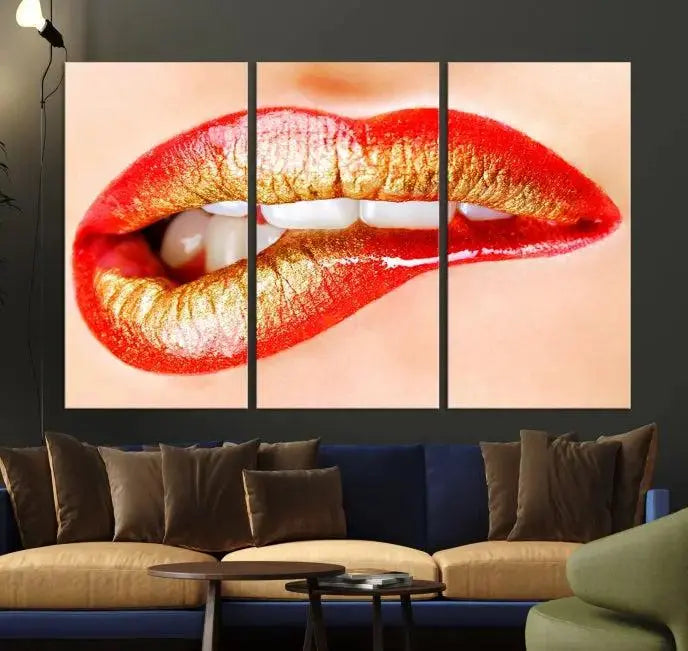 The Red Lip Bite Canvas Print, featuring a triptych of lips with red and gold lipstick, is elegantly displayed, enhancing the modern aesthetic of the minimalist room decor. This artwork is printed on high-quality polycotton canvas.