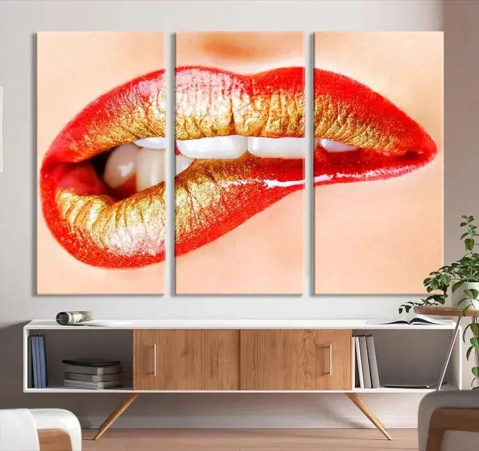 The Red Lip Bite Canvas Print, featuring a triptych of lips with red and gold lipstick, is elegantly displayed, enhancing the modern aesthetic of the minimalist room decor. This artwork is printed on high-quality polycotton canvas.