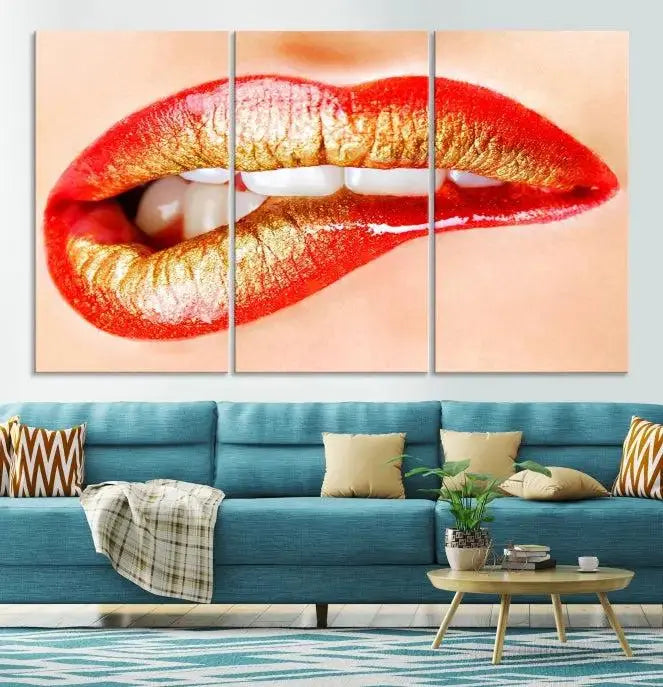 The Red Lip Bite Canvas Print, featuring a triptych of lips with red and gold lipstick, is elegantly displayed, enhancing the modern aesthetic of the minimalist room decor. This artwork is printed on high-quality polycotton canvas.